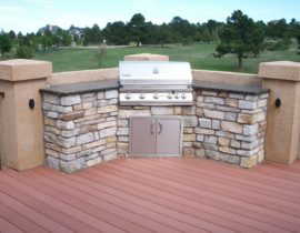 We created an outdoor cooking area with a stone base and granite countertops, and a cabinet under the grill. This is all built into a stucco corner of the deck.