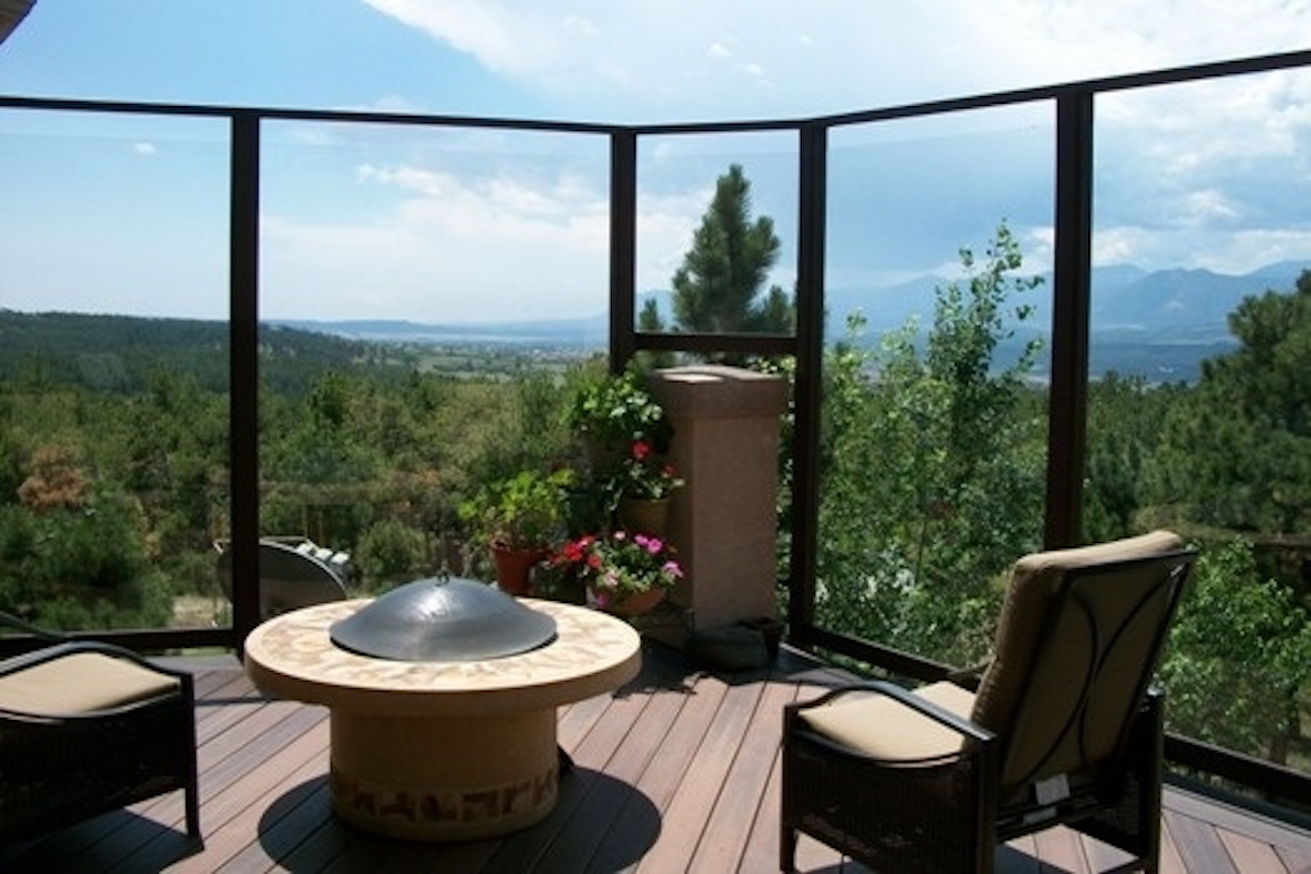 Custom built glass windbreak on a composite deck so the customers can enjoy a view of the foothills, even in the wind.