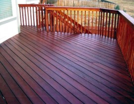 A beautiful, custom hardwood deck built with Brazilian Redwood or Massaranduba, with the decking boards laid at a 45-degree angle.