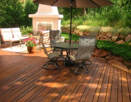 In order to create their idyllic outdoor living space, the homeowners had us build a wood deck with a wood-burning fireplace.
