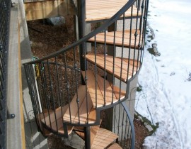 Our customer designed a railing using Cumaru hardwood treads and unique, wrought iron featuring balusters with a knuckle design.