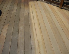 This shows the beginning stages of restoring a hardwood. One part of the deck is still very dark and dirty, while the cleaned section of deck is light colored. After the cleaning is complete, this would be stained.