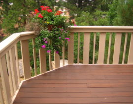 Redwood picket fence railing with narrow and wide pickets to create a unique design.