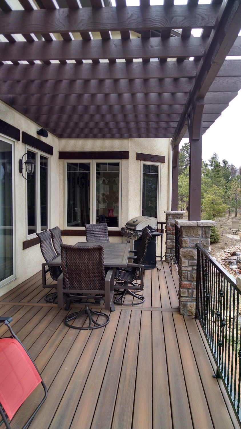 Composite deck with pergola and wrought iron railing