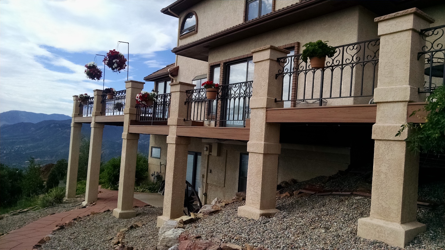 Multi-level composite deck with stucco support columns