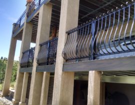 The railing used on both decks was designed by the homeowner and DBS worked with a company to have it custom made in wrought iron.