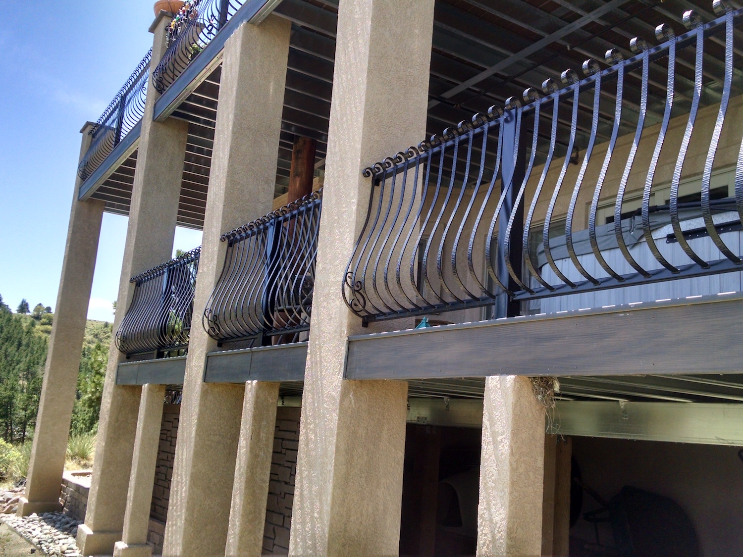 Custom designed wrought iron railing installed on composite deck