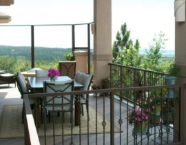 DBS built a beautiful, custom composite deck that was designed with multiple seating areas. One area serves as an outdoor dining room, the other includes a fire-pit and glass panel wind break so the view over the foothills can be enjoyed.