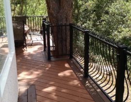 Custom Redwood deck, wrought iron deck railing, custom deck builders