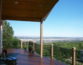 The railing system of the deck was built using wood posts and metal rail panels in a matte black.