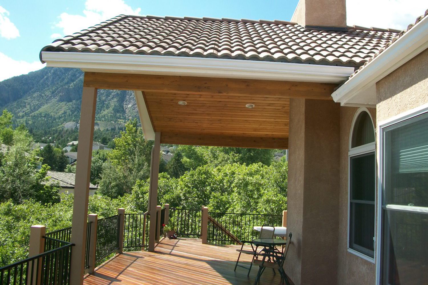 Brazilian Redwood deck with metal railing and gabled deck cover
