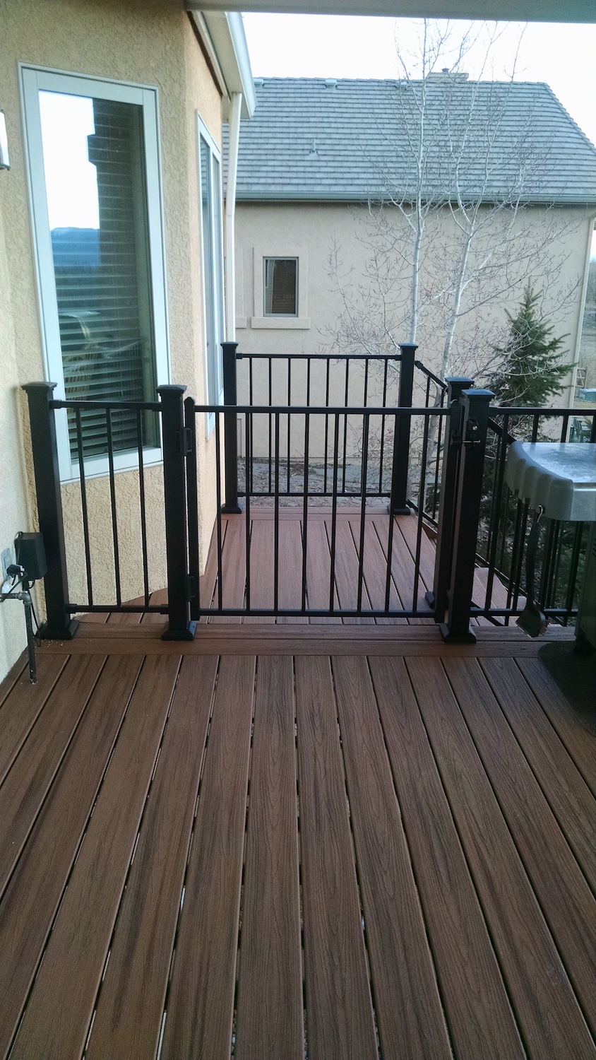 Composite deck with a gate at the top of the stairs for safety