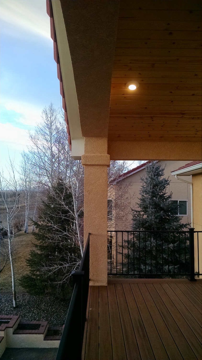 Recessed lighting on a gabled deck cover creates a beautiful area for entertaining