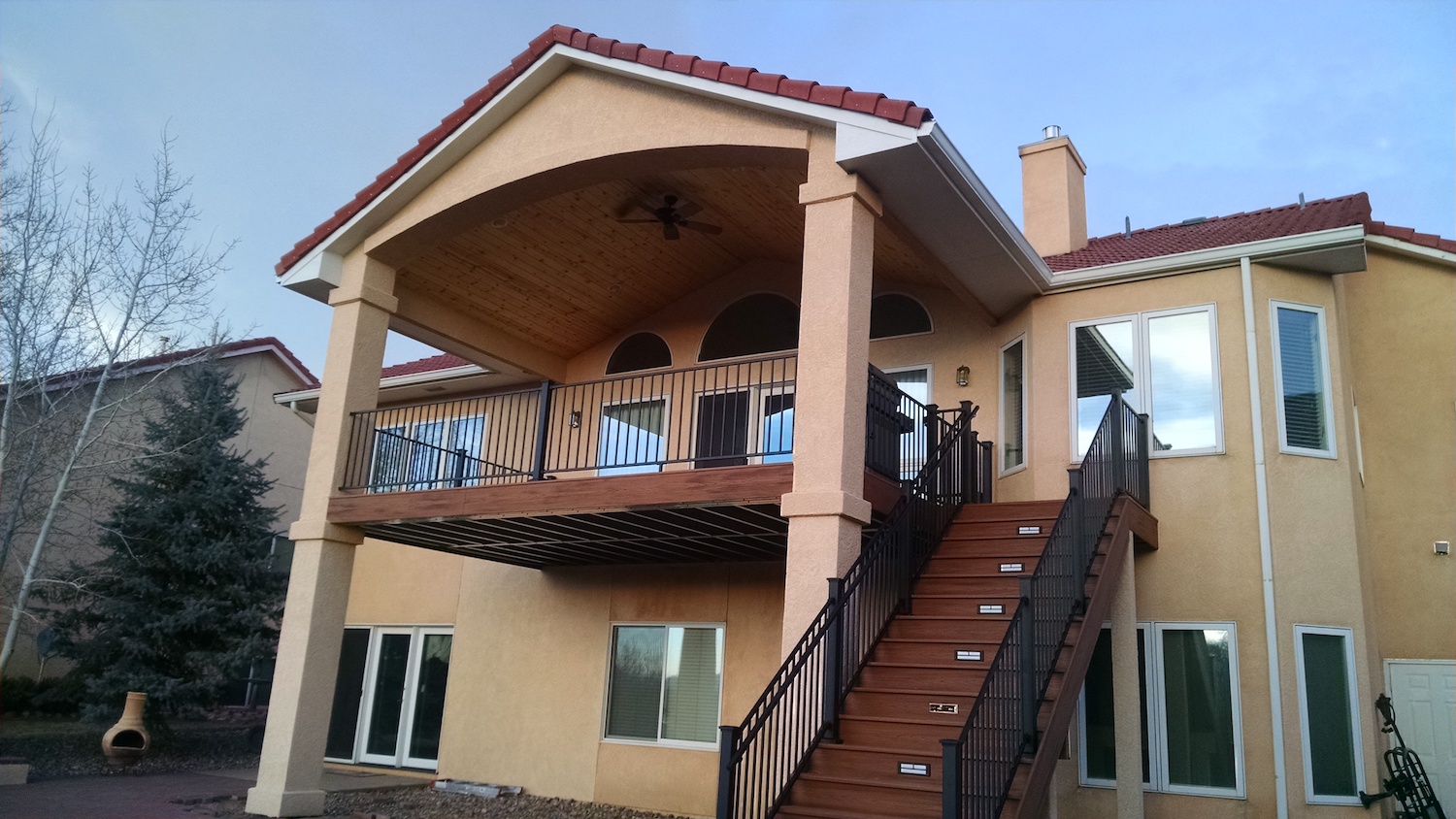 Elevated composite deck with closed stairs and gabled deck cover