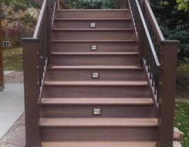 The 5'-wide closed staircase creates a statement all it's own. The homeowners added a handrail to the composite and metal railing. We also added Lake Powell step lights (from HighPoint Lighting) on alternating risers to make the stairs safer at night.