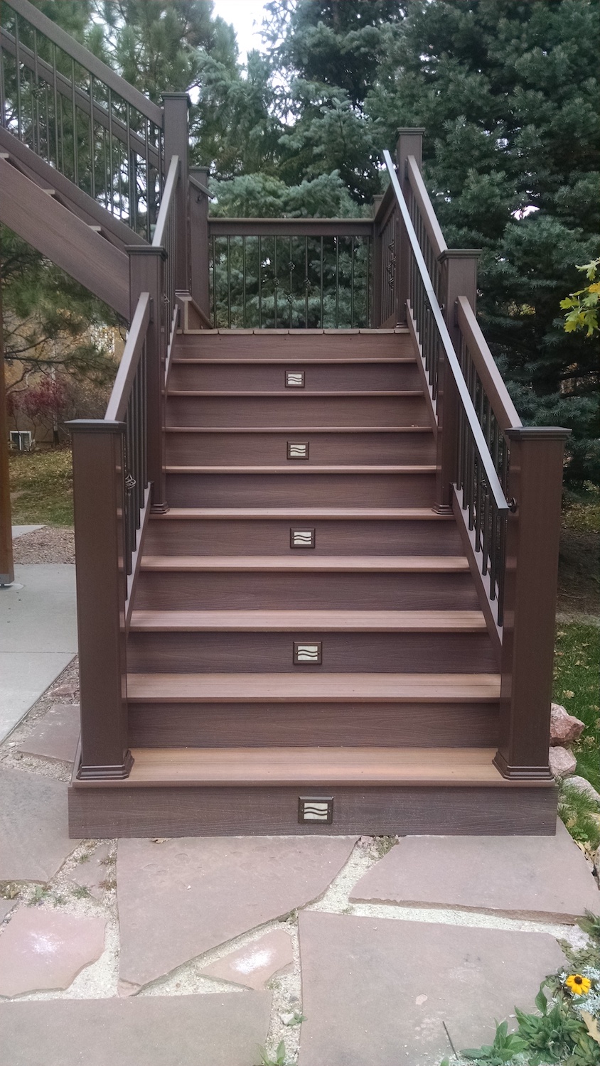 Closed deck stairs that have step lights on alternating stairs.