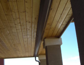 A tongue and groove pine ceiling showing the gutter system for the dry space system.