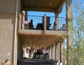 This dry space features the tongue and groove pine ceiling with recessed lighting. It allows the homeowner to place a hot tub below the deck and not worry about rain.