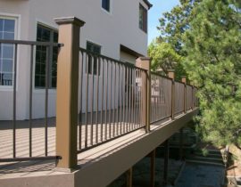 This is a metal panel railing system installed between composite posts.