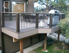Metal railing panels with square balusters between composite posts with a drink cap.