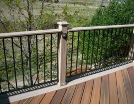 Composite posts and drink cap with black metal railing panels and railing lights on the posts.