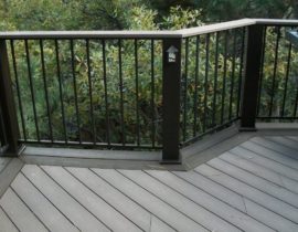 Black metal railing panels installed with composite posts and drink cap. We also added the Pikes Peak rail light to some of the posts.
