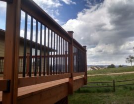 Here, we installed black metal square and twisted balusters in Redwood railing components with post caps