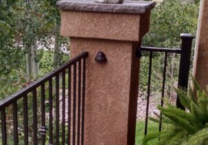 Here we installed bell shaped rail lights on the stucco columns that connect the metal railing.