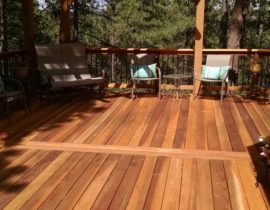 A custom designed Redwood deck that is stained with Level 1 and a cedar pergola stained with Level 3 stain.