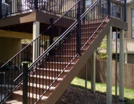 This staircase has 4'-wide, closed steps with metal panel railing and handrail.