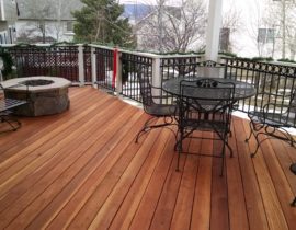 A custom Redwood deck with the boards at 45-degrees. the railing is wood components with metal panels and a ring top-accent panel.