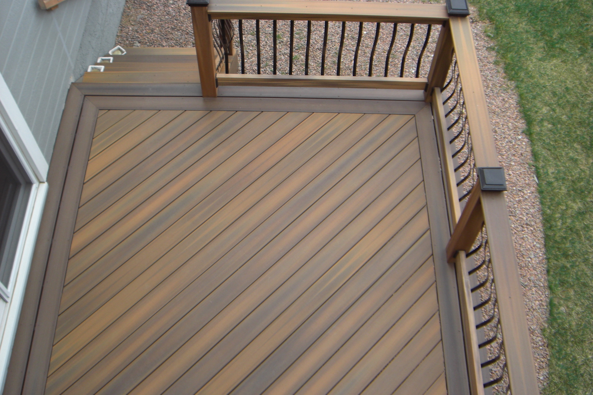 Composite deck with decking laid at 45-degrees and a double picture frame border in a contrasting color.