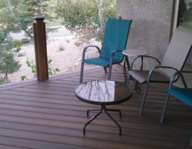 This is a composite deck laid at 45-degrees with a double picture frame. We also installed a glass railing with wood posts.