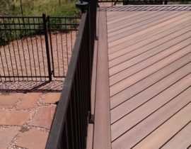 Composite decking laid at 45-degrees with a double picture frame and metal panel railing system.