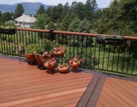 Redwood decking in a herringbone design with double picture frame stained in a contrasting color
