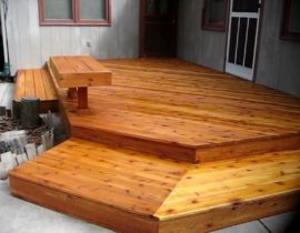 A cedar deck and custom bench that were stained with level 1 to allow the beauty of Cedar wood to show through.