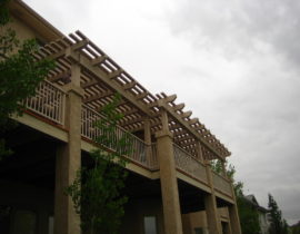 This cedar pergola was stained with a solid body stain that matched the metal railing and the house