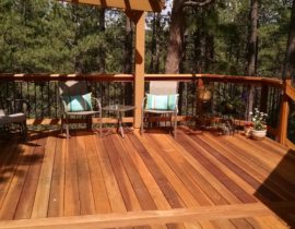 B-grade Redwood deck with cedar, tri-corner pergola. Railing has wood components and round metal balusters
