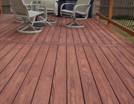 Redwood deck laid out at 90 degrees with a single divider board to avoid butt seams. The railing features wood components with metal, Vienna-style balusters.