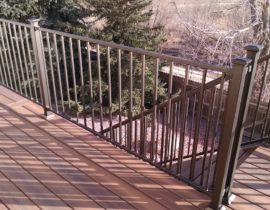 A single divider board is used to eliminate butt seams in the 90-degree boards. The railing is a bronze colored panel system with 2x2 posts.