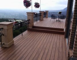 This deck was built to take advantage of an amazing view. It is a multilevel deck with 90-degree deck boards. The railing is a custom design done in wrought iron and anchored by stucco columns with stone toppers.