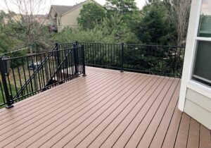 This beautiful deck was built with Moisture Shield Elevate material in the color Canoe. The railing is Fortress Fe26 in Black Sand with 2 x 2 posts.