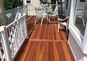 This after picture shows the new, larger Redwood deck we built. We also installed a white aluminum railing system.