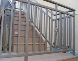 This custom, metal panel railing includes a basket design baluster and a custom top panel.
