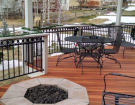 Redwood deck with 45-degree angle boards and Cedar pergola. The railing features wood components and drink cap with black metal panels and a top ring accent panel.