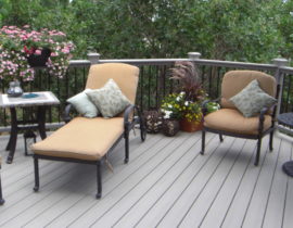 The deck boards are laid a 45-degree angle. The railing is made of metal balusters with composite posts and drink cap
