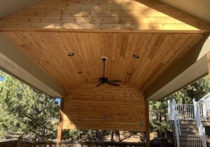 A free-standing patio cover was built with a gabled roof and vaulted ceiling in tongue and groove pine. We also installed electric outlets on the cedar half-wall and recessed lighting and ceiling fan on the ceiling.