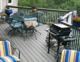 Composite deck with boards at 45-degrees. The railing has composite components and drink cap and white, round metal balusters.