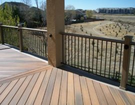 This deck is laid out in a herringbone with double divider boards. The double picture frame was done in a contrasting color. The railing is composite posts with metal panel railing and composite drink cap.