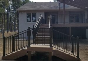 This staircase has 4'-wide, closed steps that lead to a landing. At the landing, there are two smaller staircases, one on each side.